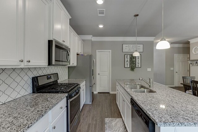 kitchen with crown molding, a sink, stainless steel appliances, white cabinetry, and visible vents