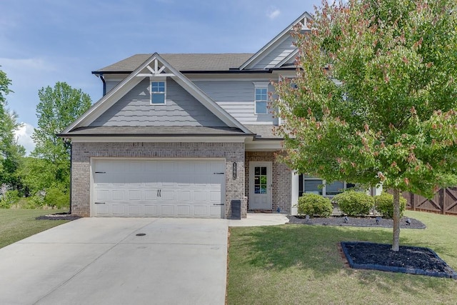 craftsman inspired home with concrete driveway, a front lawn, and brick siding