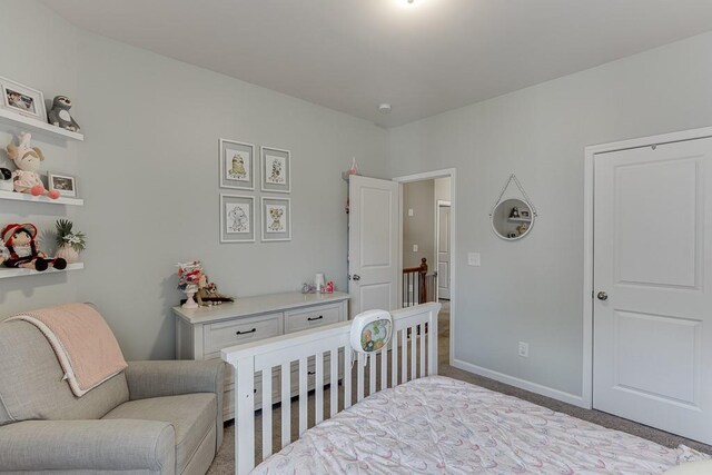 bedroom featuring carpet floors and baseboards