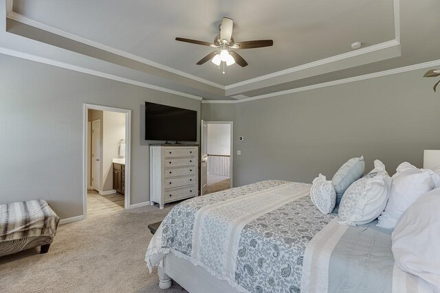 bedroom with crown molding, a raised ceiling, baseboards, and light carpet
