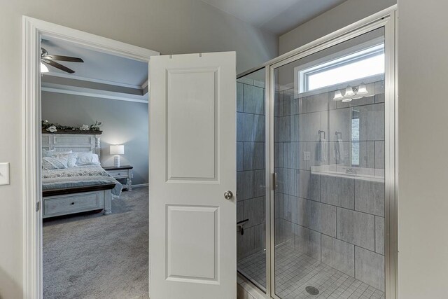 bathroom featuring crown molding, a ceiling fan, connected bathroom, and a shower stall