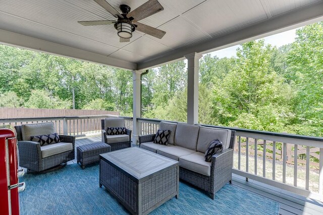 wooden deck with a ceiling fan and an outdoor living space