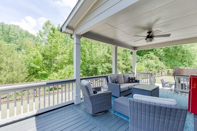 deck featuring ceiling fan and outdoor lounge area