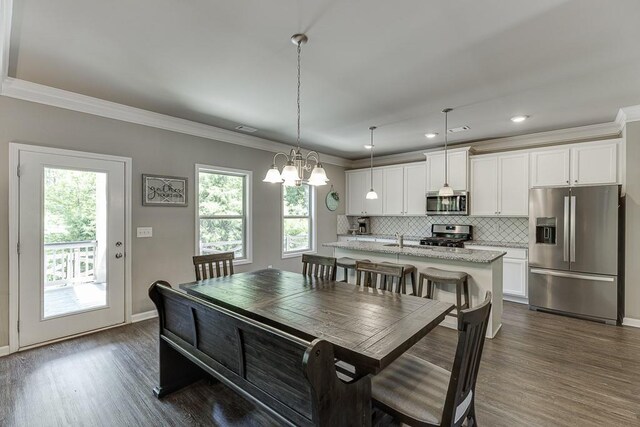 dining room featuring ornamental molding, baseboards, dark wood-type flooring, recessed lighting, and a chandelier