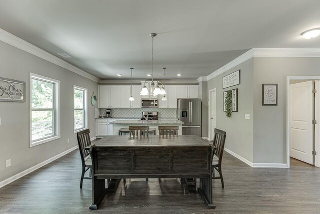 dining space with baseboards, ornamental molding, dark wood finished floors, and visible vents