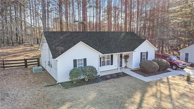 single story home with cooling unit, roof with shingles, fence, and driveway