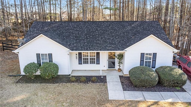 view of front of home featuring a patio and roof with shingles