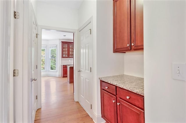 corridor with light hardwood / wood-style flooring