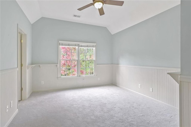 unfurnished room featuring ceiling fan, light colored carpet, and vaulted ceiling