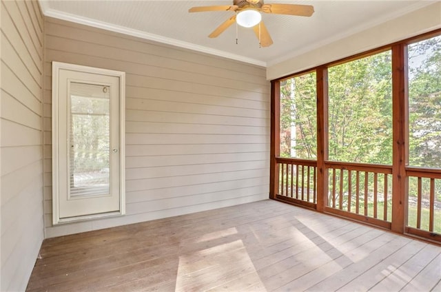 unfurnished sunroom with ceiling fan