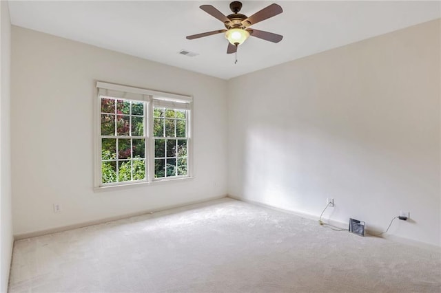 empty room featuring light colored carpet and ceiling fan