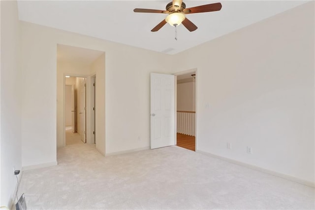 unfurnished bedroom with ensuite bathroom, ceiling fan, and light carpet