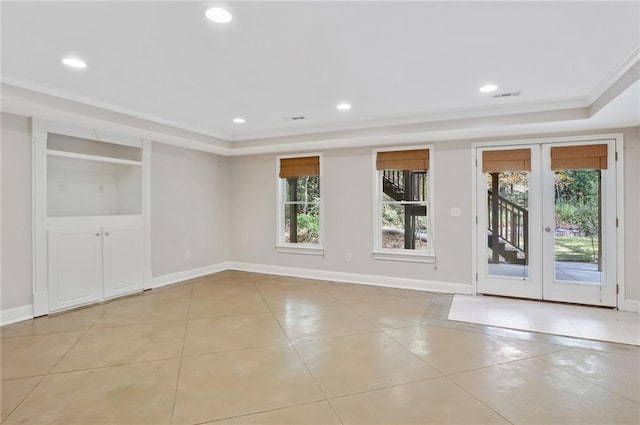 tiled empty room featuring french doors and crown molding