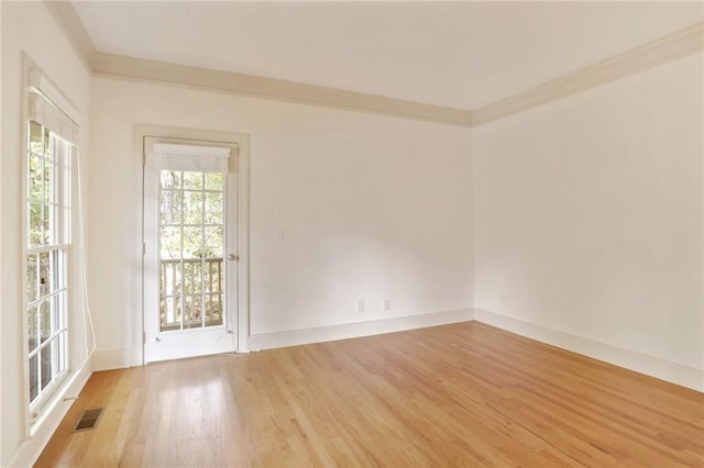 unfurnished room featuring wood-type flooring and crown molding