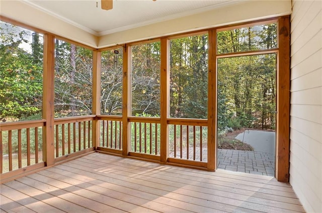 unfurnished sunroom with ceiling fan