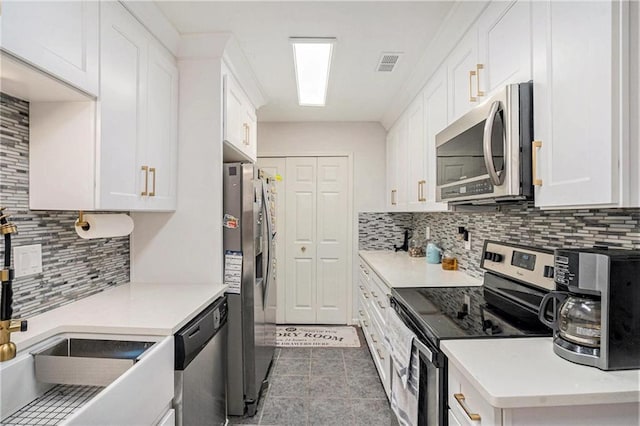 502 Brighton Pt, Atlanta, GA 30328 - kitchen with stainless steel appliances, a sink, white cabinetry, and backsplash