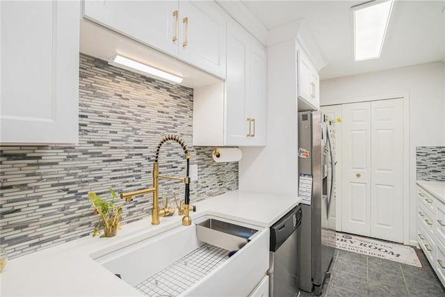 502 Brighton Pt, Atlanta, GA 30328 - kitchen with appliances with stainless steel finishes, decorative backsplash, white cabinetry, a sink, and light countertops