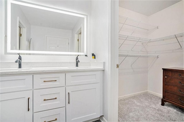 502 Brighton Pt, Atlanta, GA 30328 - bathroom with double vanity, a spacious closet, and baseboards