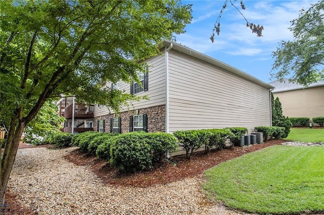 502 Brighton Pt, Atlanta, GA 30328 - view of property exterior with a lawn, central air condition unit, and stone siding