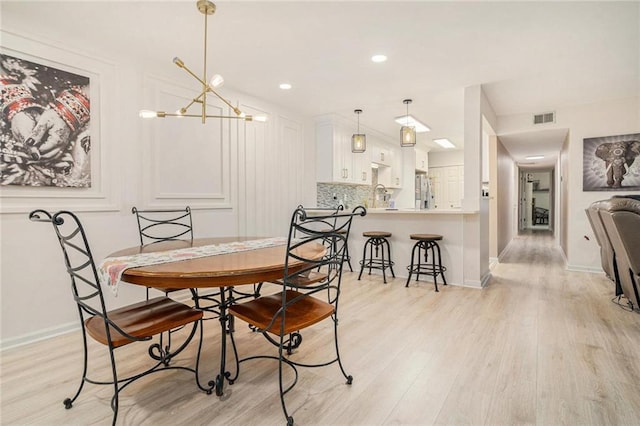502 Brighton Pt, Atlanta, GA 30328 - dining room with light wood-style flooring, baseboards, a chandelier, and recessed lighting