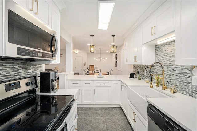 502 Brighton Pt, Atlanta, GA 30328 - kitchen with appliances with stainless steel finishes, a sink, tasteful backsplash, and white cabinetry