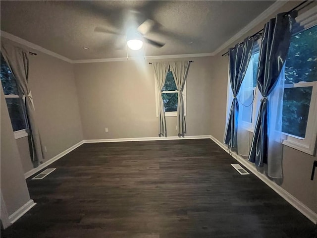 spare room featuring a textured ceiling, dark hardwood / wood-style flooring, ceiling fan, and crown molding