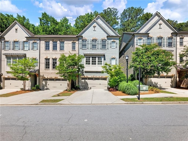 2506 Skyland Dr NE Unit 17, Atlanta, GA 30319 - view of front of home featuring driveway, brick siding, and an attached garage