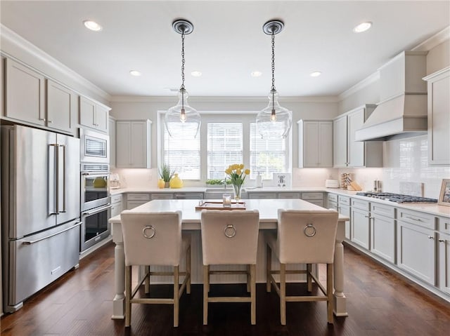 2506 Skyland Dr NE Unit 17, Atlanta, GA 30319 - kitchen featuring appliances with stainless steel finishes, tasteful backsplash, a kitchen island, light countertops, and recessed lighting