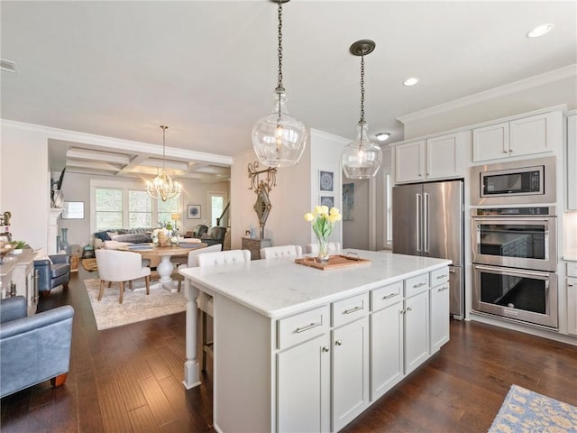 2506 Skyland Dr NE Unit 17, Atlanta, GA 30319 - kitchen with stainless steel appliances, open floor plan, recessed lighting, crown molding, and white cabinetry