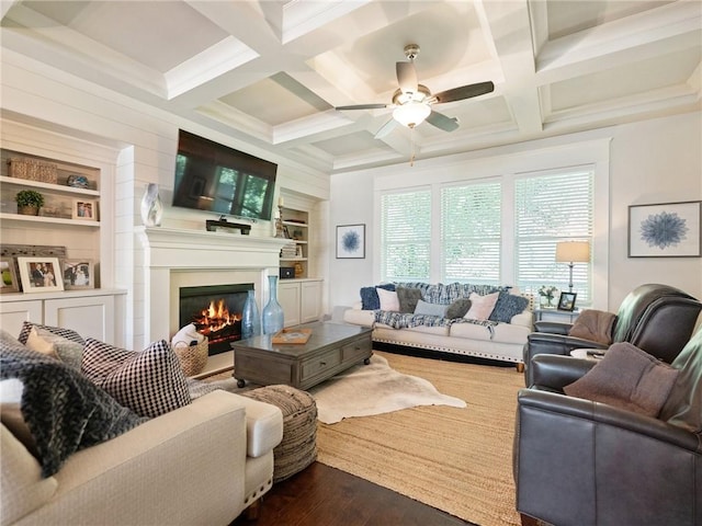 2506 Skyland Dr NE Unit 17, Atlanta, GA 30319 - living area with a warm lit fireplace, dark wood-type flooring, a ceiling fan, built in shelves, and coffered ceiling