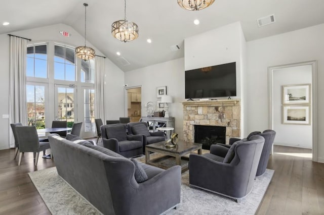 2506 Skyland Dr NE Unit 17, Atlanta, GA 30319 - living room with a chandelier, wood finished floors, high vaulted ceiling, a stone fireplace, and recessed lighting