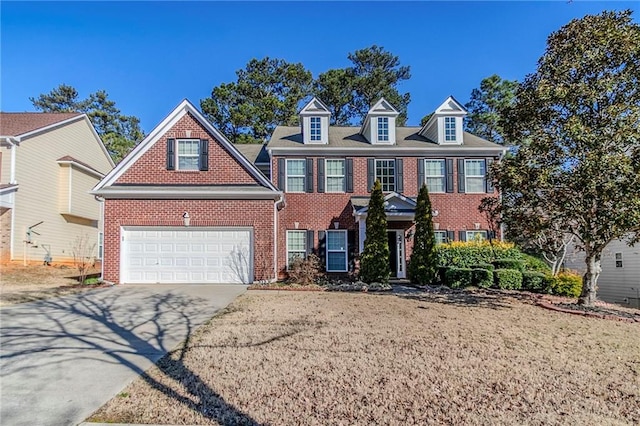 view of front of property with driveway, an attached garage, and brick siding