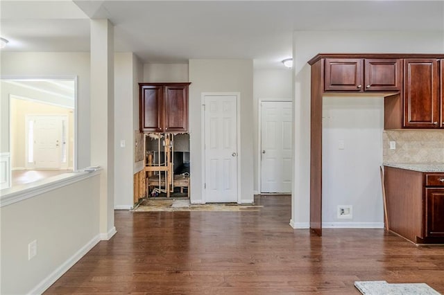 interior space featuring dark wood finished floors and baseboards