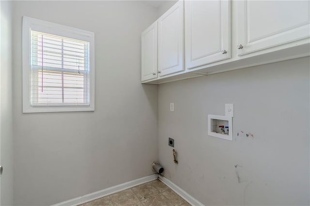 washroom with hookup for a washing machine, hookup for a gas dryer, cabinet space, hookup for an electric dryer, and baseboards