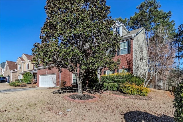 obstructed view of property with driveway, brick siding, and an attached garage