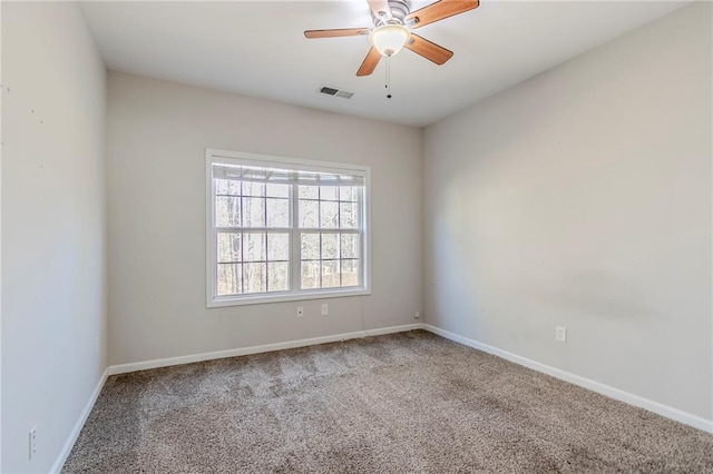 unfurnished room with a ceiling fan, carpet, visible vents, and baseboards