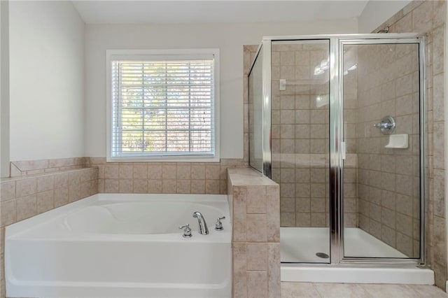 bathroom with a shower stall and a bath