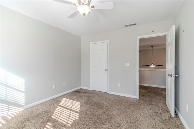 unfurnished bedroom featuring a ceiling fan, carpet flooring, visible vents, and baseboards