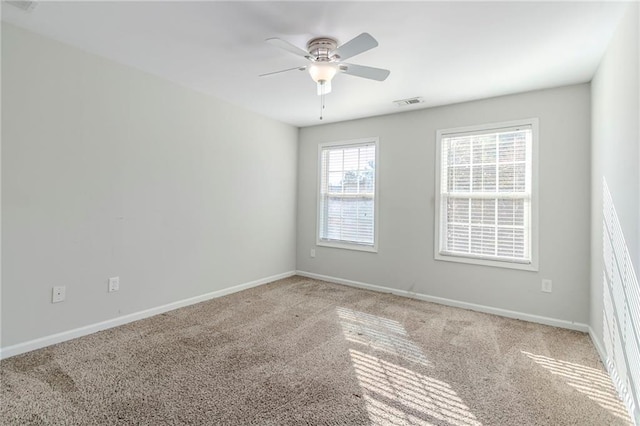 unfurnished room with carpet floors, baseboards, and a ceiling fan