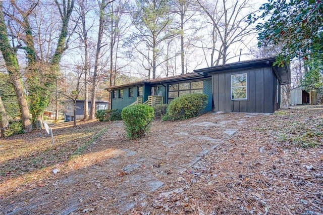 ranch-style home with a storage shed