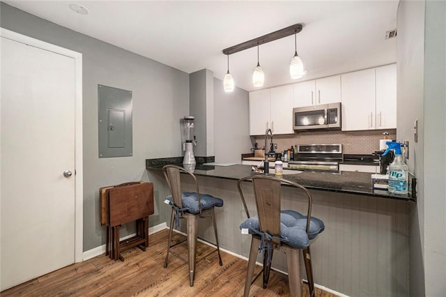 3501 Roswell Rd NE Unit 211, Atlanta, GA 30305 - kitchen with stainless steel appliances, electric panel, tasteful backsplash, and a peninsula