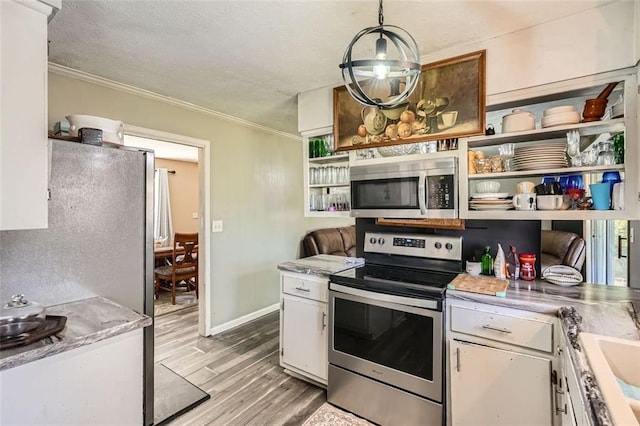 kitchen with stainless steel appliances, crown molding, pendant lighting, light hardwood / wood-style flooring, and white cabinets