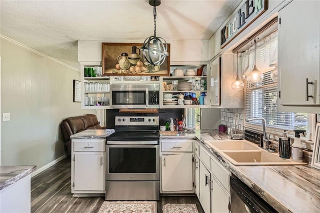 kitchen featuring pendant lighting, white cabinets, dark hardwood / wood-style floors, ornamental molding, and appliances with stainless steel finishes