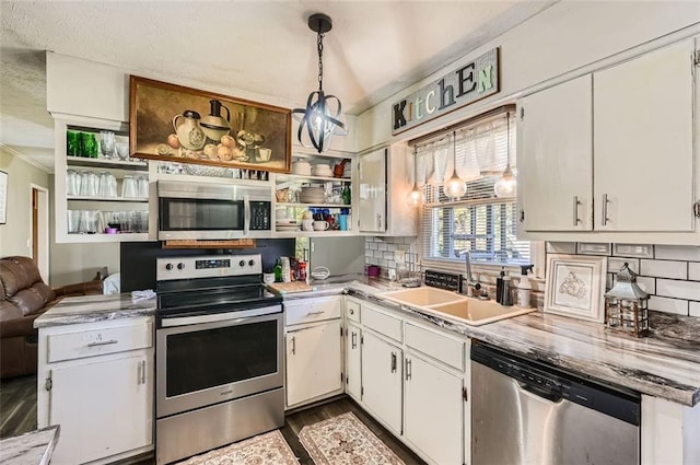 kitchen featuring white cabinetry, sink, decorative light fixtures, decorative backsplash, and appliances with stainless steel finishes