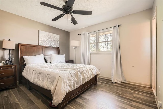 bedroom with a textured ceiling, dark hardwood / wood-style flooring, and ceiling fan