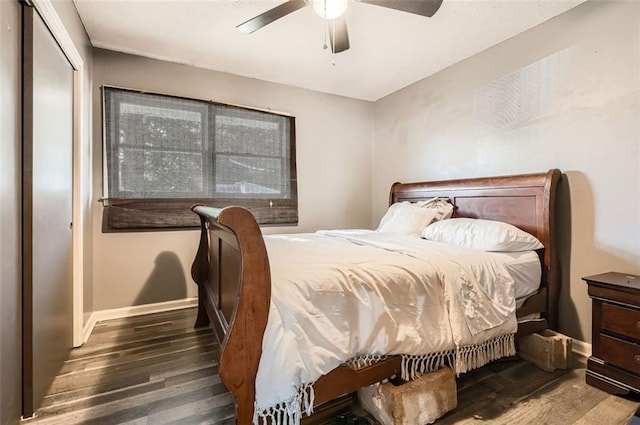 bedroom featuring ceiling fan, a closet, and dark wood-type flooring