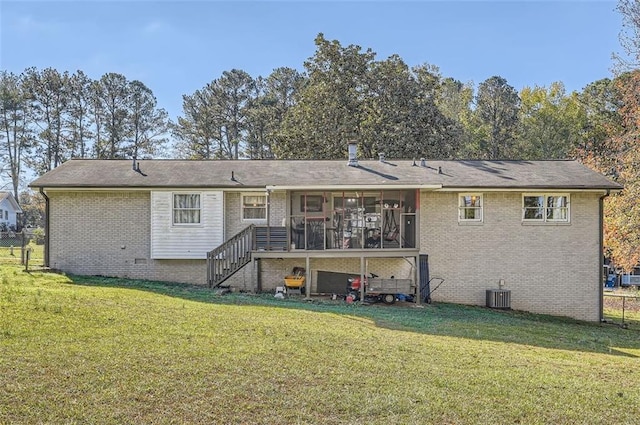 back of property featuring a yard, central AC unit, and a sunroom