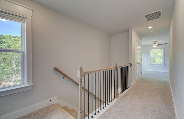 hallway with visible vents, an upstairs landing, recessed lighting, carpet floors, and baseboards