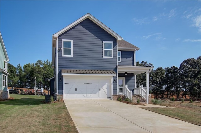 traditional-style house with a front yard, concrete driveway, and a garage