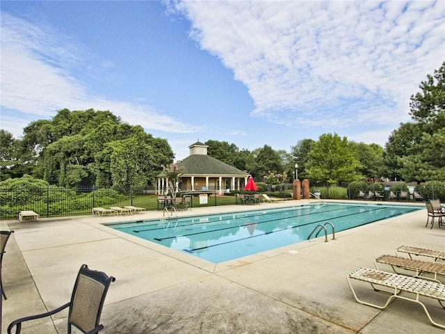 pool featuring a patio area and fence